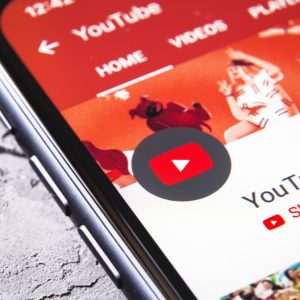Smartphone screen displaying the youtube app interface with a prominent subscribe button, indicating a call to action for viewers to subscribe to a channel as part of youtube marketing strategies.